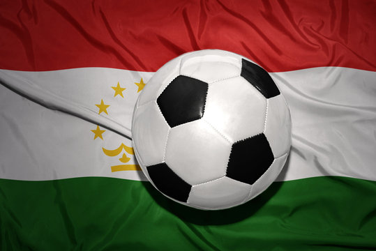 black and white football ball on the national flag of tajikistan