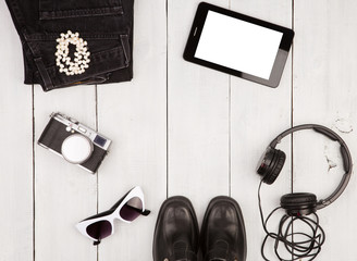 shoes, jeans, tablet pc, camera, headphones, sunglasses on white