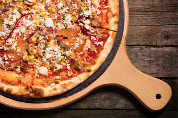 Pizza with tuna fish, vegetables, and mozzarela cheese served on