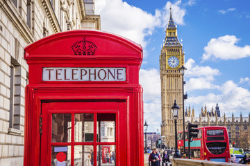 Traditional red british telephone box with Big Ben and Double Decker bus at the background on a...