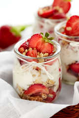 Strawberry yogurt dessert with nuts and muesli, perfect as a healthy breakfast
