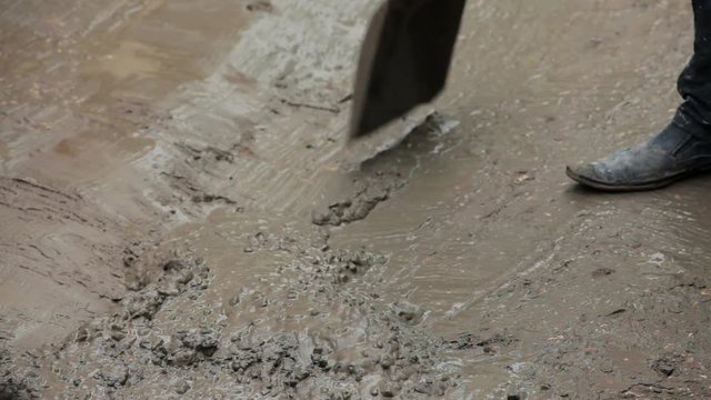 Man Mixing Cement On The Ground