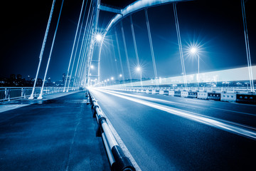 Fototapeta na wymiar traffic trails on bridge,chongqing china,blue toned image.