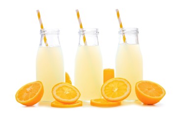 Obraz na płótnie Canvas Three bottles of cold lemonade with lemon slices and straws isolated on a white background