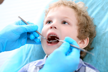 Close up of boy having his teeth examined by a dentist