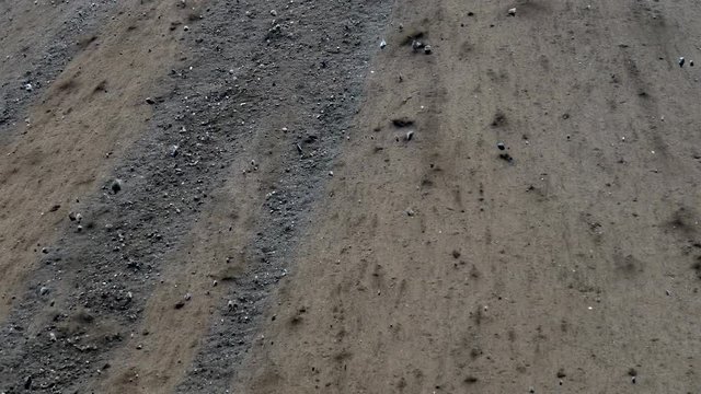 Rocks and boulders sliding down hillside.