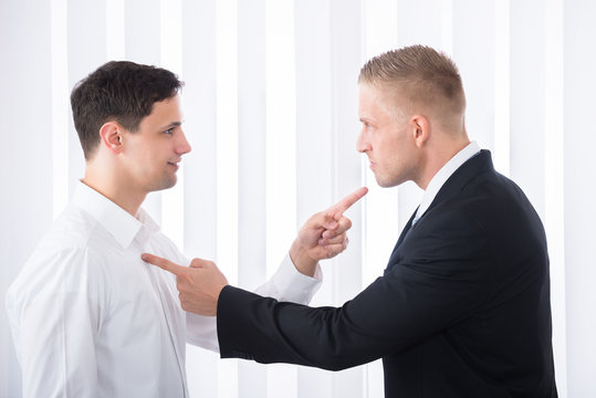 Businessmen Pointing Finger At Each Other
