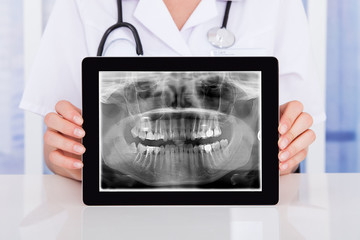 Doctor Holding Digital Tablet At Clinic