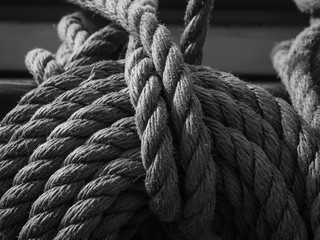 Fototapeta na wymiar black and white of coil of line on a traditional tallship or sailing ship