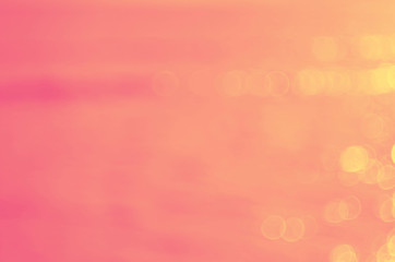 Blur tropical sunset beach with bokeh sun light wave abstract background. Travel concept.