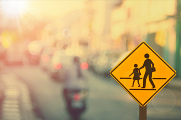 School sign on blur traffic road abstract background.