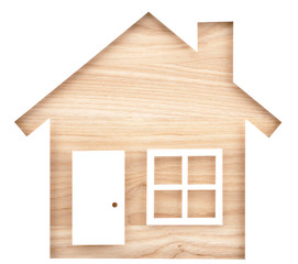 Obraz na płótnie Canvas House shaped paper cutout on natural wood lumber. Isolated on white background. 