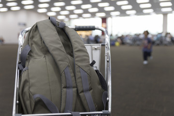 Naklejka na ściany i meble rucksack on cart in airport terminal building