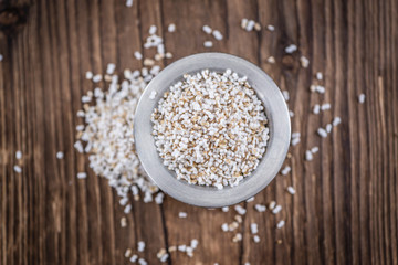 Wooden table with a portion of puffed Amaranth (selective focus)