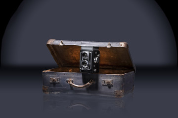 old camera placed in nice old.suitcase , travel concept