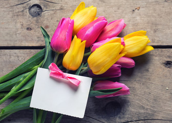 Bunch of yellow and pink spring tulips and  vempty tag  on vinta