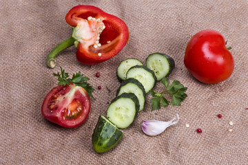 sliced cucumber and red pepper with tomato and spices