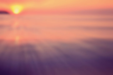 Blur tropical sunset beach with smooth wave abstract background.