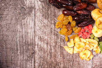 Dried fruits on wooden background in close up photo