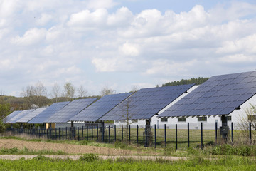 Solar Power Station on the spring flowering Meadow in the sunny Day