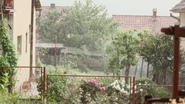Heavy Rain Falling over houses in rural background 
