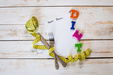 measuring tape on a wooden background. diet concept