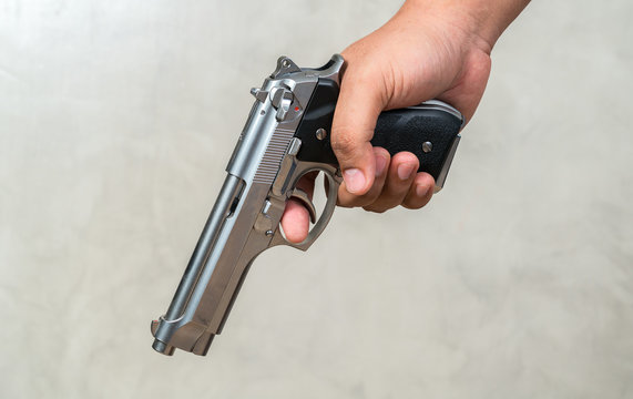 hands hold a gun
