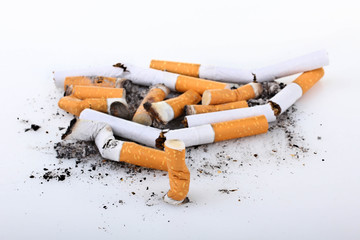 a large number of cigarettes with orange filter extinguished on a white isolated background