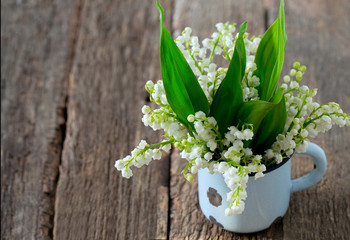 lilies of the valley on the wooden surface