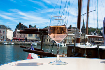 Glass with rose vine  in old French fisherman village, Normandy