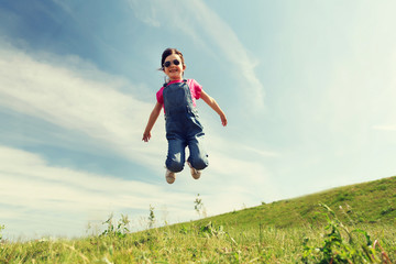 happy little girl jumping high outdoors