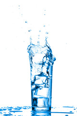 Glass of water with ice cubes on white background