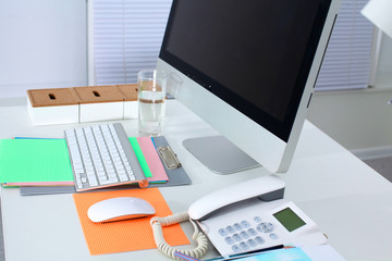 Table designer working space with a computer and paperwork