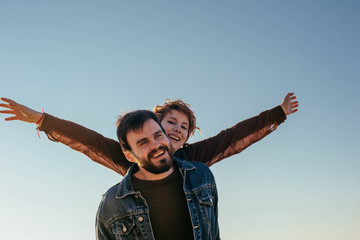 happy loving couple having fun on beach at sunset