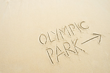Handwritten message with arrow pointing the way to Olympic Park written in smooth sand