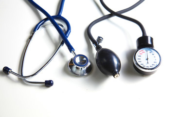 Silver stethoscope lying down on an laptop, toned blue