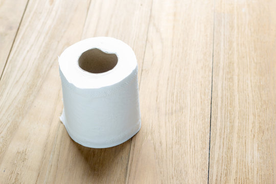 tissue roll on wooden table