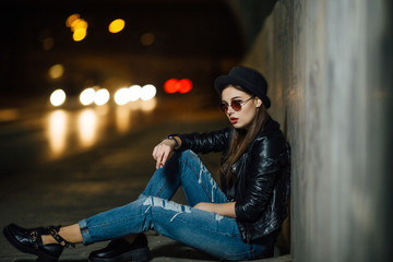 Young girl sitting on the floor and smoke