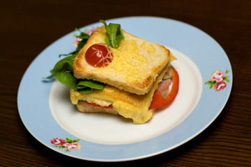 Toasted sandwich with bacon, cheese, tomato 