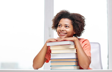 happy african student girl with books at home