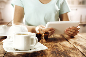 woman with coffee and tablet 