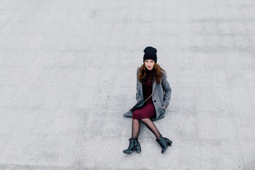 Young woman sitting on the street