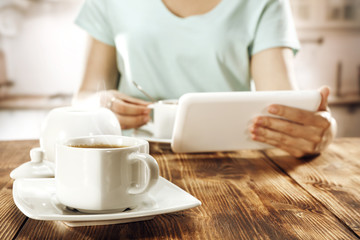 woman with coffee and tablet 