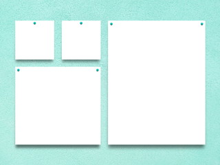 Close-up of four nailed square and rectangular blank frames on aqua rough wall background