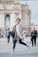 Young girl jumping on the city street