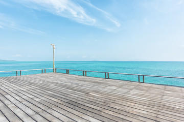Obraz premium wooden floor with beautiful ocean and blue sky scenery