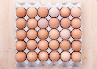 Eggs in the package, on the wooden table