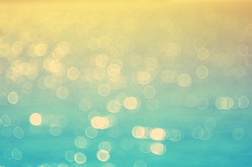 Blur tropical sunset beach with bokeh sun light wave abstract background. Travel concept.