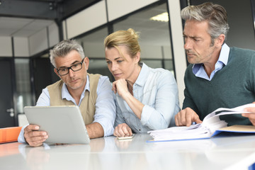 Business people in a meeting using tablet