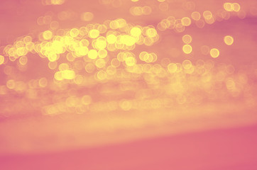 Blur tropical sunset beach with bokeh sun light wave abstract background. Travel concept.